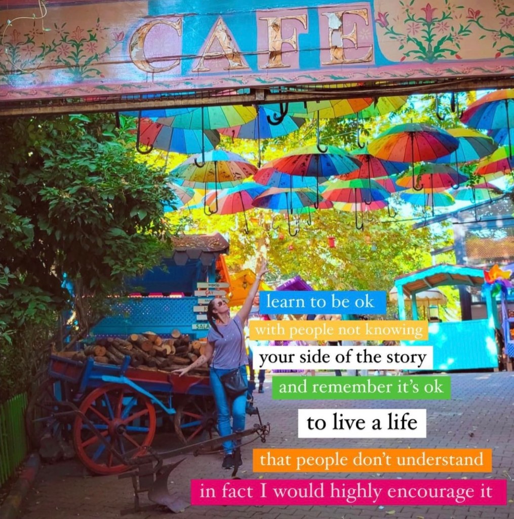 Blata Cafe in Istanbul with woman reaching up to many colourful umbrellas lining up above with text on screen reading learn to be ok with people not knowing your side of the story and remember it's ok to live a life that people don't understand in fact I would highly encourage it